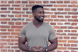 Portrait in front of a brick wall.